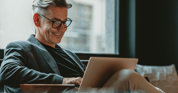 man sits at laptop in lobby