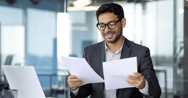 businessman in suit sits at desk