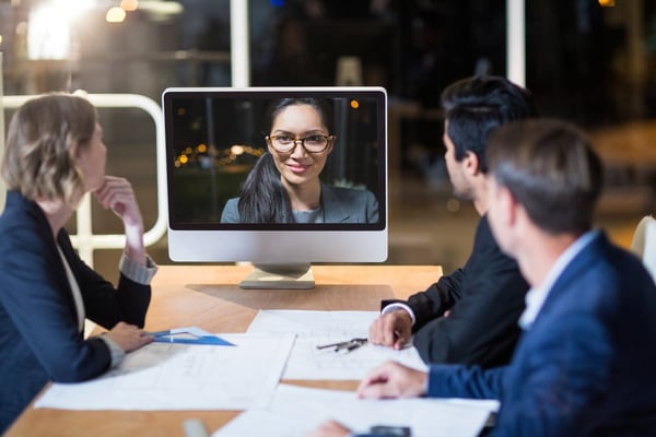 group having meeting with someone on computer screen