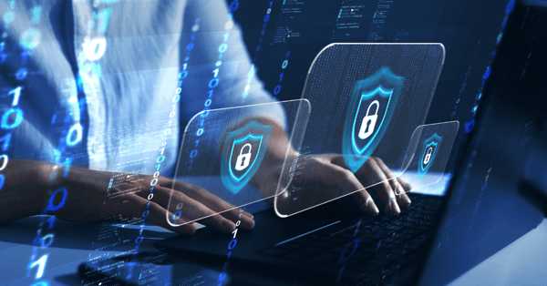 person typing on laptop with data security icons present