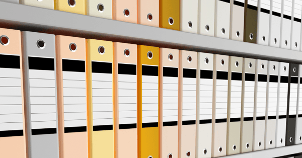 line up of ring binders on shelves